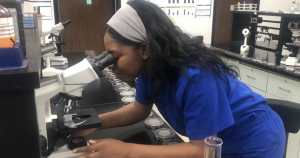 Joycelyn Williams leaning over microscope